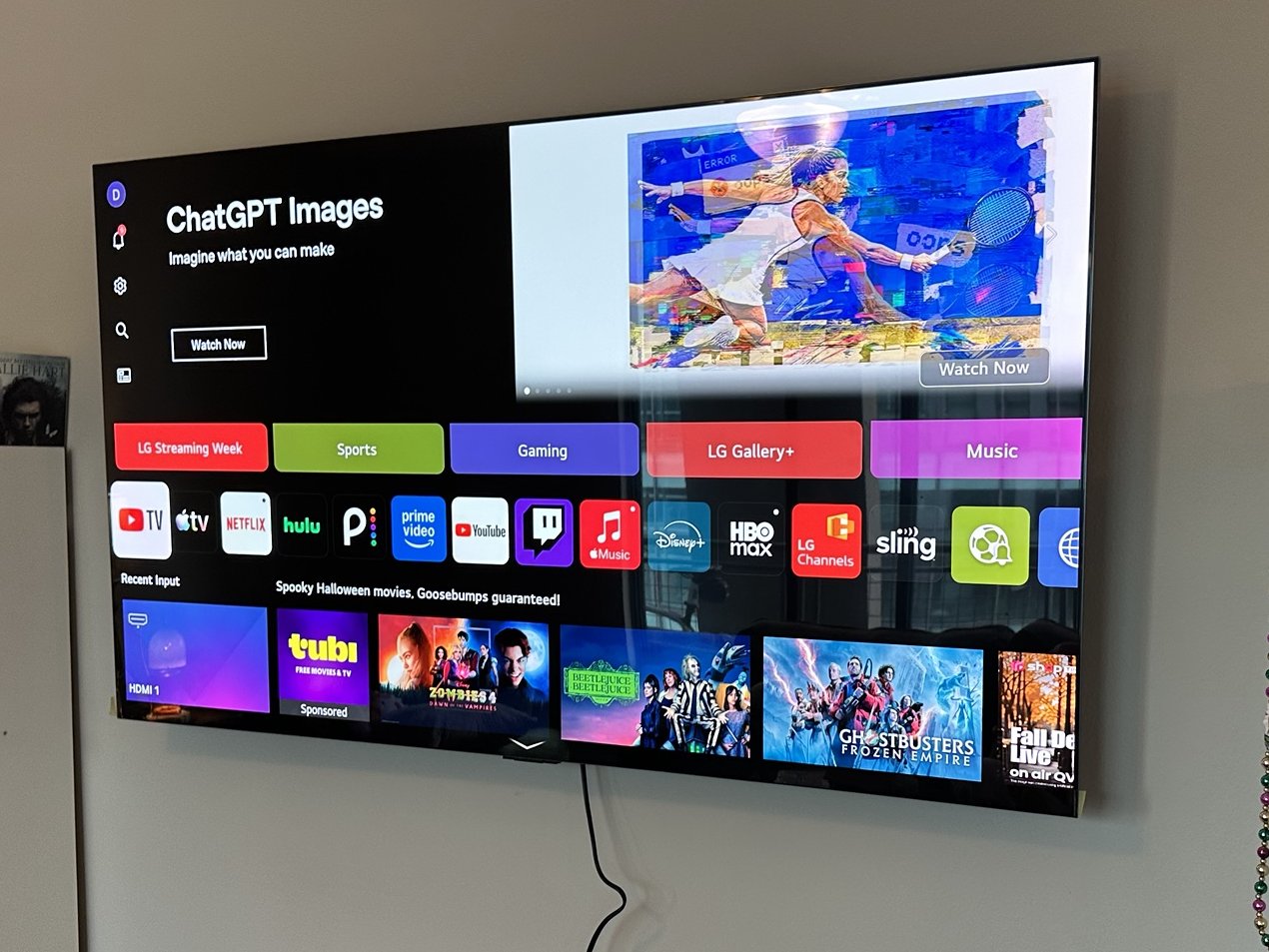 LG TV on a full-motion mount with its power cord left on the wall surface