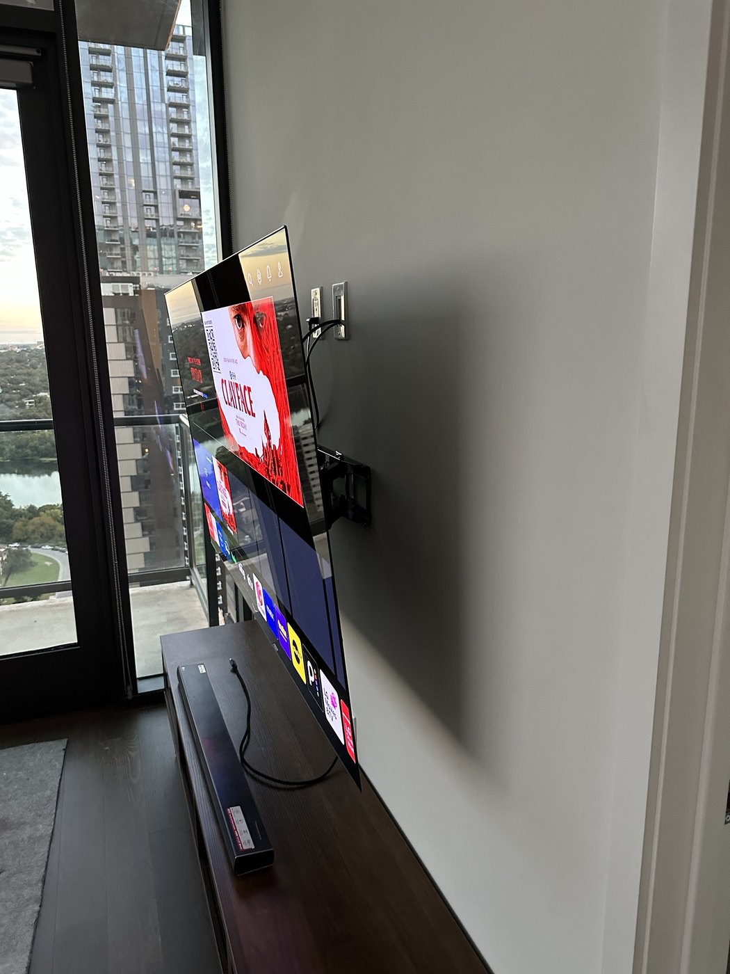 LG OLED TV on a full-motion mount pulled out from the wall