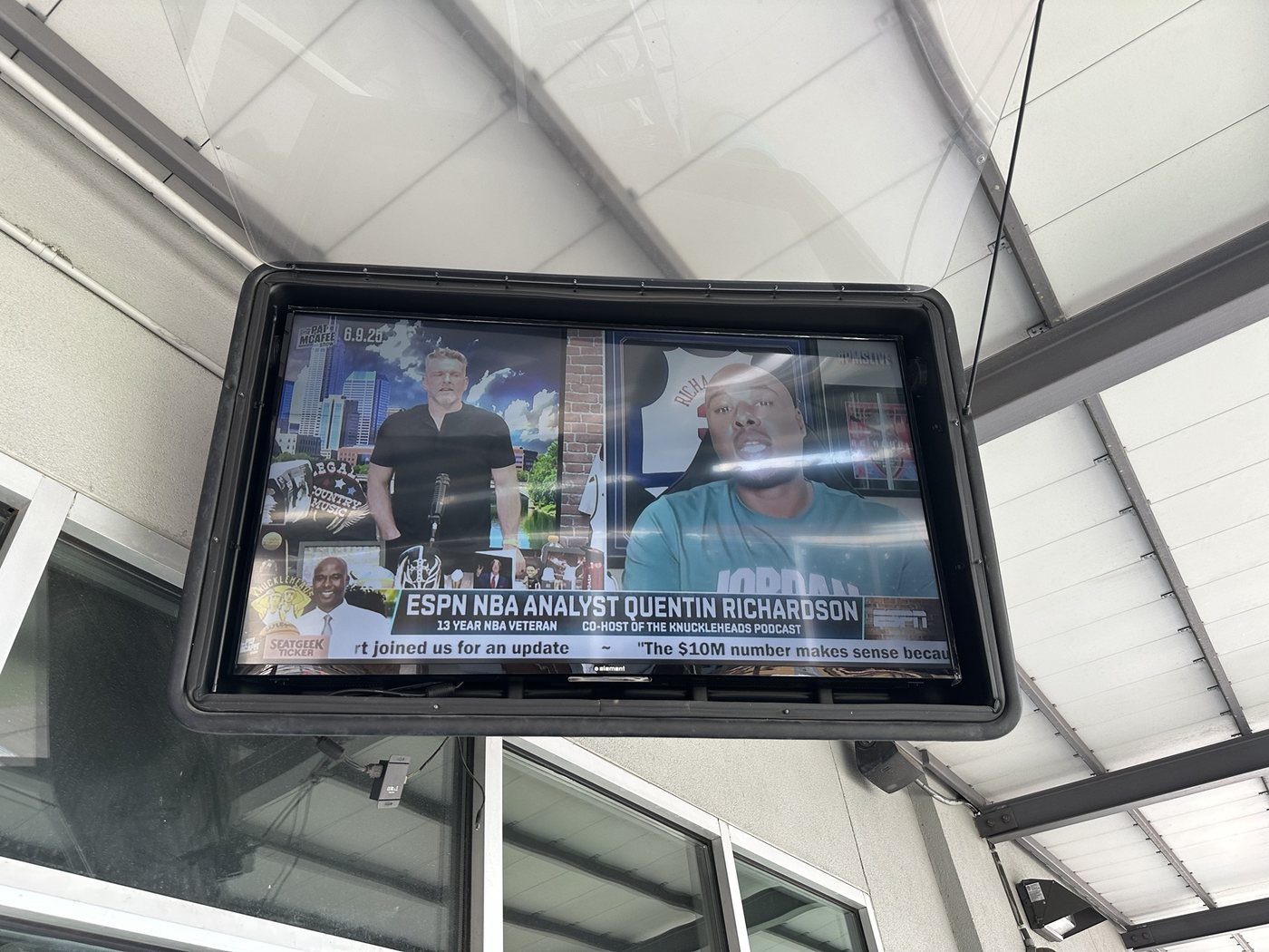TV in a weatherproof enclosure hung under a covered patio